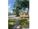 Community parking lot surrounded by well-maintained lawns and verdant trees at 6040 Peregrine Ave # A01, Orlando, FL 32819