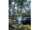 Community parking lot shaded by mature trees, offering a serene and convenient parking area at 6040 Peregrine Ave # A01, Orlando, FL 32819