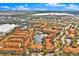 This aerial view shows the community, nearby shopping and dining, and a distant view of Tampa Bay at 6141 Metrowest Blvd # 303, Orlando, FL 32835