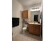 Bathroom with tiled floor, cabinet, mirror, sink, and toilet at 6141 Metrowest Blvd # 303, Orlando, FL 32835