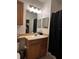 Bathroom with vanity, mirror, shower with dark curtain, and toilet at 6141 Metrowest Blvd # 303, Orlando, FL 32835