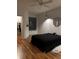 Minimalist bedroom design with hardwood floors, closet, and an interesting cat at 6141 Metrowest Blvd # 303, Orlando, FL 32835