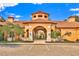 Community clubhouse boasts a terracotta tile roof, barrel-vaulted entry, and a covered walkway to interior courtyard at 6141 Metrowest Blvd # 303, Orlando, FL 32835