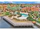The community pool overlooks the pond and is surrounded by palm trees and lounge chairs at 6141 Metrowest Blvd # 303, Orlando, FL 32835