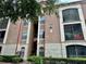 Three-story condo building featuring a combination of tan and off-white exterior walls at 6141 Metrowest Blvd # 303, Orlando, FL 32835