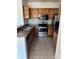 Kitchen featuring stainless steel appliances, wood cabinets, and tile backsplash at 6141 Metrowest Blvd # 303, Orlando, FL 32835