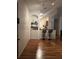 Open-concept room with hardwood floors, a built-in shelf, and seating at the kitchen counter at 6141 Metrowest Blvd # 303, Orlando, FL 32835