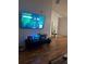 Living room boasts hardwood floors, a TV, and stylish décor, creating a comfortable space at 6141 Metrowest Blvd # 303, Orlando, FL 32835
