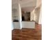Spacious living room with hardwood floors, a kitchen view, and built-in shelves at 6141 Metrowest Blvd # 303, Orlando, FL 32835