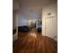 Stylish living room featuring hardwood floors, a modern sofa, and a flat-screen TV at 6141 Metrowest Blvd # 303, Orlando, FL 32835