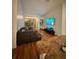 Spacious living room featuring hardwood floors, a comfortable sofa, and modern amenities at 6141 Metrowest Blvd # 303, Orlando, FL 32835