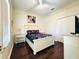 Bedroom featuring a queen-sized bed, hardwood floors, and closet space at 618 N Hampton Dr, Davenport, FL 33897
