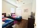Comfortable bedroom featuring two twin beds, dark wood floors, and closet space at 618 N Hampton Dr, Davenport, FL 33897