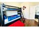 Bedroom featuring dark wood floors, a bunk bed, and colorful decor at 618 N Hampton Dr, Davenport, FL 33897