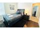 Comfortable bedroom with a full-sized bed, dark wood floors, and a modern nightstand at 618 N Hampton Dr, Davenport, FL 33897