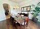 Elegant dining room with a large glass table, modern chandelier, and wood flooring at 618 N Hampton Dr, Davenport, FL 33897