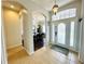 Inviting foyer with tile flooring, arched doorways, and decorative light fixture at 618 N Hampton Dr, Davenport, FL 33897