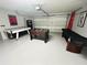 Spacious garage featuring a pool table, foosball table, and an additional covered table at 618 N Hampton Dr, Davenport, FL 33897