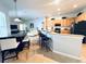 Open kitchen featuring a breakfast bar, stylish black and steel appliances and view to the Gathering room at 618 N Hampton Dr, Davenport, FL 33897