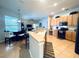 Bright kitchen with a breakfast bar, warm wood cabinetry and an open-concept layout at 618 N Hampton Dr, Davenport, FL 33897