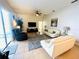 Bright living room with tile floors, white sofas, a ceiling fan, and access to the exterior patio at 618 N Hampton Dr, Davenport, FL 33897