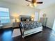 Stylish main bedroom featuring dark wood floors, and a decorative ceiling fan with attractive furnishings at 618 N Hampton Dr, Davenport, FL 33897