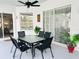 Covered patio with a dining table set, ceiling fan, sliding glass doors, and nice potted plants at 618 N Hampton Dr, Davenport, FL 33897
