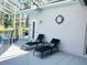 Covered patio featuring lounge chairs with cushions, small accent table, and a unique clock at 618 N Hampton Dr, Davenport, FL 33897