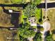 Aerial shot of home with solar panels, complemented by a private dock and bridge access, offering sustainable lakeside living at 6200 Alligator Lake E Shr, St Cloud, FL 34771