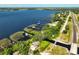 Stunning aerial view of a waterfront property with private docks along a serene lake and adjacent to a scenic roadway at 6200 Alligator Lake E Shr, St Cloud, FL 34771