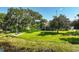 Waterside backyard view with dock, manicured lawn, and majestic, mature trees at 6200 Alligator Lake E Shr, St Cloud, FL 34771