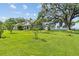 Sprawling backyard with waterfront view, lush lawn and mature trees at 6200 Alligator Lake E Shr, St Cloud, FL 34771
