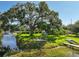 Backyard with lush lawn featuring a fire pit, shed, and waterway at 6200 Alligator Lake E Shr, St Cloud, FL 34771