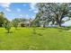 Expansive backyard with lush green lawn leading to a waterfront home at 6200 Alligator Lake E Shr, St Cloud, FL 34771