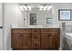 Bathroom features a dual sink vanity with dark wood cabinets, stone countertops, and modern lighting at 6200 Alligator Lake E Shr, St Cloud, FL 34771