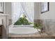 Bright bathroom soaking tub with a large window view at 6200 Alligator Lake E Shr, St Cloud, FL 34771