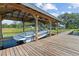 View of the modern boat lift containing a boat, with a wooden dock and tranquil water creating a scenic waterfront at 6200 Alligator Lake E Shr, St Cloud, FL 34771