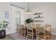 Comfortable dining room with natural light with seating for eight with decorations on wall at 6200 Alligator Lake E Shr, St Cloud, FL 34771