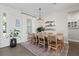 Bright dining room with a large table, woven chairs, and stylish decor for Gathering gatherings at 6200 Alligator Lake E Shr, St Cloud, FL 34771