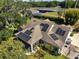 Aerial view highlighting solar panels atop a well-maintained home, set in a serene, green neighborhood at 6200 Alligator Lake E Shr, St Cloud, FL 34771