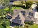 Aerial view of a home featuring modern solar panels on the roof, set amidst a lush, green landscape at 6200 Alligator Lake E Shr, St Cloud, FL 34771