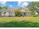 Charming two-story home features a well-manicured lawn, mature trees and a welcoming front porch at 6200 Alligator Lake E Shr, St Cloud, FL 34771