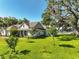 Charming lakefront home with lush lawn, mature trees, and water views at 6200 Alligator Lake E Shr, St Cloud, FL 34771