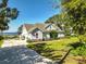 Two-story home with landscaped yard, a long drive, and picturesque lake views at 6200 Alligator Lake E Shr, St Cloud, FL 34771