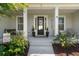 The charming front porch features stylish decor and offers a relaxing outdoor seating area at 6200 Alligator Lake E Shr, St Cloud, FL 34771