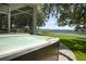 Outdoor hot tub with serene lake views and a backdrop of lush trees at 6200 Alligator Lake E Shr, St Cloud, FL 34771