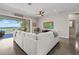 Comfortable living room featuring a plush white sectional sofa and seamless indoor/outdoor flow with lake views at 6200 Alligator Lake E Shr, St Cloud, FL 34771