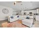 Bright living room featuring a large sectional sofa, modern decor, and an open-concept layout to the kitchen at 6200 Alligator Lake E Shr, St Cloud, FL 34771