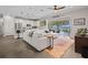 Open living space with white sofa, kitchen island, and seamless flow to the outdoor patio with lake views at 6200 Alligator Lake E Shr, St Cloud, FL 34771