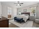 Serene main bedroom features a ceiling fan, carpet, a bench, and windows to let in plenty of natural light at 6200 Alligator Lake E Shr, St Cloud, FL 34771